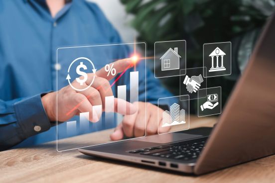 Dłoń wskazująca na ekran laptopa